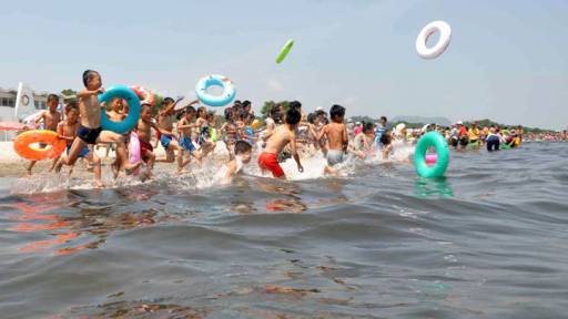 Schoolchildren play in the water