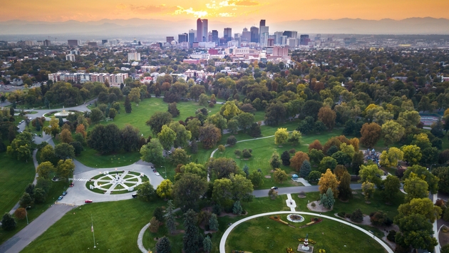 Sunset over Denver cityscape, aerial view from the city park (photo via Creative-Family / iStock / Getty Images Plus)